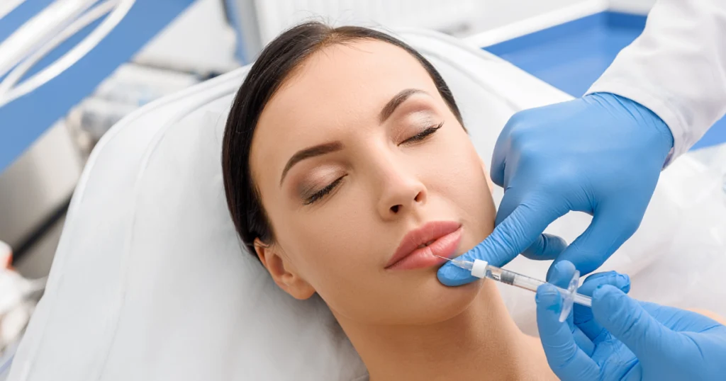 Woman receiving lip filler injection at clinic in Hoboken, NJ