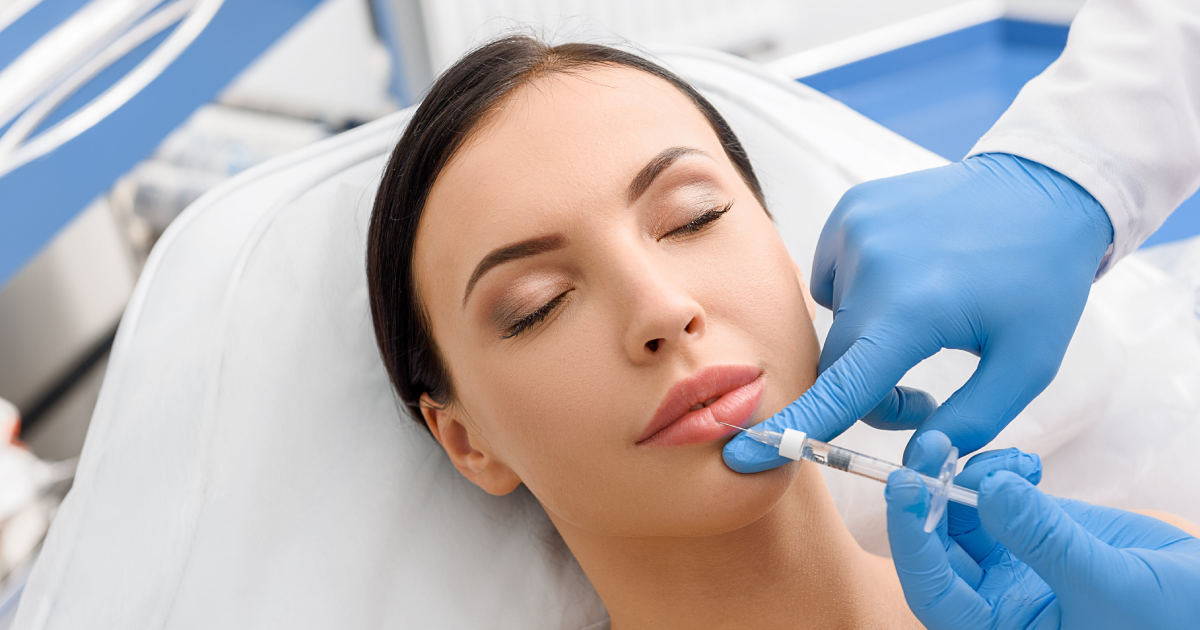 Woman receiving lip filler injection at clinic in Hoboken, NJ