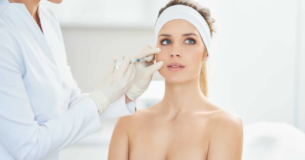 Doctor in a white coat giving a facial injection to a patient during a Botox treatment in Hoboken, NJ.